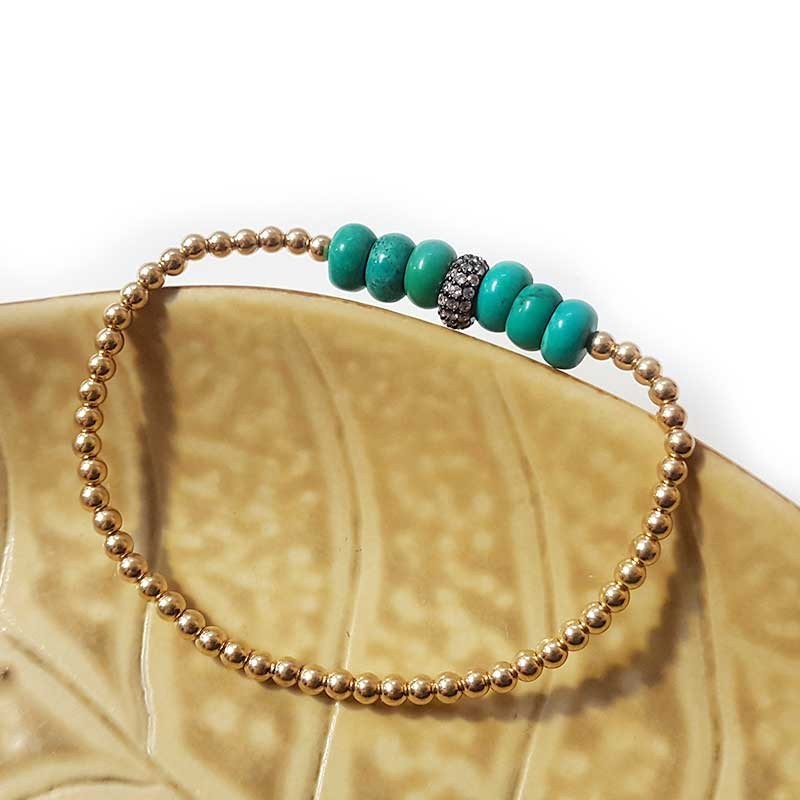 Armband met gouden en turquoise ronde kralen